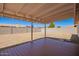 Covered patio and large backyard area with shade in the background at 3114 W Villa Maria Dr, Phoenix, AZ 85053