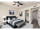 Staged bedroom with modern decor, ceiling fan, and a view into an attached bathroom at 3114 W Villa Maria Dr, Phoenix, AZ 85053