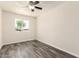 Bright bedroom featuring a large window for natural light and new luxury modern flooring at 3114 W Villa Maria Dr, Phoenix, AZ 85053
