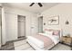 Comfortable bedroom featuring a ceiling fan, a cozy bed, ample closet space, and new luxury flooring at 3114 W Villa Maria Dr, Phoenix, AZ 85053