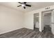 Empty bedroom features ceiling fan, wood-look flooring and attached bathroom at 3114 W Villa Maria Dr, Phoenix, AZ 85053