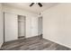 Bright bedroom with sliding closet doors, updated ceiling fan, and durable wood-look flooring at 3114 W Villa Maria Dr, Phoenix, AZ 85053