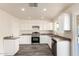 Spacious kitchen with white cabinetry, stainless steel appliances, modern countertop and luxury flooring at 3114 W Villa Maria Dr, Phoenix, AZ 85053