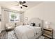 Cozy bedroom featuring a ceiling fan, a comfortable bed, and large bright window, and ample lighting at 3114 W Villa Maria Dr, Phoenix, AZ 85053