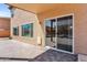 Spacious back patio features a sliding glass door, windows and hardscape flooring at 3423 E Superior Rd, San Tan Valley, AZ 85143