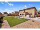 Expansive backyard with a desert landscape, artificial turf, and a built-in outdoor grill at 3423 E Superior Rd, San Tan Valley, AZ 85143