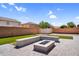 Beautiful backyard featuring a stone fire pit, hardscape, and artificial turf at 3423 E Superior Rd, San Tan Valley, AZ 85143