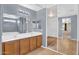 Bright bathroom featuring a double vanity, framed mirrors, walk-in closet and a neutral color palette at 3423 E Superior Rd, San Tan Valley, AZ 85143