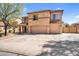 Two-story home featuring a three-car garage and a desert-landscaped front yard under a sunny blue sky at 3423 E Superior Rd, San Tan Valley, AZ 85143