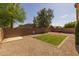 Large fenced backyard with gravel and a small section of grassy area at 3905 E Derringer Way, Gilbert, AZ 85297