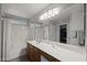 A well-lit bathroom with a dual shower/tub and a vanity with a large mirror at 3905 E Derringer Way, Gilbert, AZ 85297