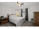 This is a well-lit bedroom, with neutral walls, a ceiling fan and a window with gray curtains at 3905 E Derringer Way, Gilbert, AZ 85297