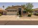 Charming single-story home featuring a two-car garage and desert landscaping for easy maintenance at 3905 E Derringer Way, Gilbert, AZ 85297