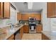 Well-equipped kitchen featuring wood cabinets, granite countertops, and stainless steel appliances at 3905 E Derringer Way, Gilbert, AZ 85297