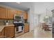 Bright kitchen with wood cabinets, stainless steel microwave and a view of the dining area at 3905 E Derringer Way, Gilbert, AZ 85297