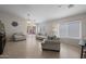 Bright living room with tiled floor, ceiling fan, and sliding glass doors to the backyard patio at 3905 E Derringer Way, Gilbert, AZ 85297