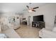 Open-concept living room with tile flooring and a large TV above a media console at 3905 E Derringer Way, Gilbert, AZ 85297