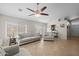 Spacious living room features comfortable seating, large windows, and stylish ceiling fan at 3905 E Derringer Way, Gilbert, AZ 85297