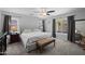 This is the main bedroom with a large bed, bench, and dual windows with gray curtains at 3905 E Derringer Way, Gilbert, AZ 85297