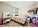 Cozy bedroom with a vibrant floral-patterned bedspread, a vanity, and ample space for personal touches at 3916 S 79Th Ln, Phoenix, AZ 85043
