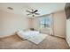 Serene bedroom with plush carpeting, a large window, and neutral decor for a relaxing atmosphere at 3916 S 79Th Ln, Phoenix, AZ 85043