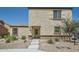 Two-story home with a neutral color, low maintenance desert landscaping, and a well-lit entryway at 3916 S 79Th Ln, Phoenix, AZ 85043