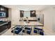 Stylish kitchen featuring a granite island with seating, stainless steel appliances, and ample cabinet space at 3916 S 79Th Ln, Phoenix, AZ 85043