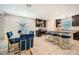 Elegant kitchen with granite countertops, island seating, dark cabinets, and stainless steel appliances at 3916 S 79Th Ln, Phoenix, AZ 85043