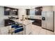 Modern kitchen featuring dark wood cabinets, stainless steel appliances, granite countertops and island seating at 3916 S 79Th Ln, Phoenix, AZ 85043