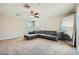 Spacious living room with a comfortable sectional sofa, ceiling fan, and a full length mirror at 3916 S 79Th Ln, Phoenix, AZ 85043