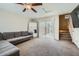Cozy living room featuring plush carpeting, a ceiling fan, a large mirror, and a sliding glass door at 3916 S 79Th Ln, Phoenix, AZ 85043