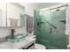 Modern bathroom with a glass vessel sink, marble countertop, and a stylish glass-enclosed shower with contemporary fixtures at 4013 E Delta Cir, Mesa, AZ 85206