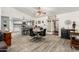 Open dining area featuring a round table, modern chairs, and wood-look tile flooring, flowing seamlessly into the kitchen at 4013 E Delta Cir, Mesa, AZ 85206