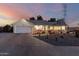 Inviting single-story home featuring a two-car garage, landscaped yard with cacti, and a charming gazebo at dusk at 4013 E Delta Cir, Mesa, AZ 85206