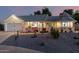 Charming single-story home with a well-maintained lawn, unique gazebo, and inviting front porch at twilight at 4013 E Delta Cir, Mesa, AZ 85206