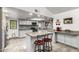 Well-lit kitchen with white cabinets, granite countertops, a mosaic backsplash, and stainless steel appliances, creating a modern space at 4013 E Delta Cir, Mesa, AZ 85206
