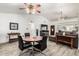 Open living room with wood-look tile flooring, comfortable seating, and a modern entertainment center with a large television at 4013 E Delta Cir, Mesa, AZ 85206