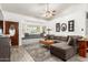 Bright living room featuring a sectional sofa, bay window with seating, and tasteful decor at 4013 E Delta Cir, Mesa, AZ 85206