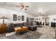 Open-concept living room with a sectional sofa, view into the kitchen, and tiled floors at 4013 E Delta Cir, Mesa, AZ 85206