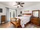 Inviting main bedroom with hardwood floors, a ceiling fan, and a cozy seating area, flooded with natural light at 4013 E Delta Cir, Mesa, AZ 85206