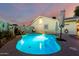 Sparkling backyard swimming pool illuminated in the evening, enhanced by custom wall art and inviting relaxation space at 4013 E Delta Cir, Mesa, AZ 85206