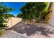 A blank canvas awaits in the backyard with a gravel area, stone trim, and block wall at 4037 E Elmwood St, Mesa, AZ 85205