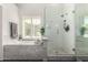 Bright bathroom with a glass-enclosed shower, soaking tub, and classic white subway tile at 4037 E Elmwood St, Mesa, AZ 85205