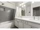 Modern bathroom with double vanity, a bathtub with gray tiled walls, and a shower curtain at 4037 E Elmwood St, Mesa, AZ 85205