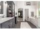 Bathroom featuring marble tile, vanity, standalone soaking tub, and separate walk-in shower at 4037 E Elmwood St, Mesa, AZ 85205