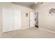 Carpeted bedroom includes closet, doorway and neutral colored paint at 4037 E Elmwood St, Mesa, AZ 85205