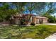 Beautiful home with mature trees, lush green lawn, and a welcoming facade at 4037 E Elmwood St, Mesa, AZ 85205