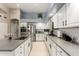 Spacious kitchen featuring stainless appliances, an island with seating, and plentiful counter space at 4037 E Elmwood St, Mesa, AZ 85205