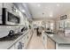 Galley kitchen with stainless steel appliances, white cabinetry, and an island with seating at 4037 E Elmwood St, Mesa, AZ 85205