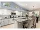 Bright kitchen featuring white cabinets, stainless steel appliances, and a center island with counter seating at 4037 E Elmwood St, Mesa, AZ 85205